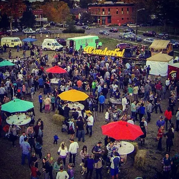 Colorful tents and a crowd at Sustainability Park, seen from above