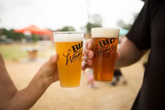 Two pint glasses raised in a cheers