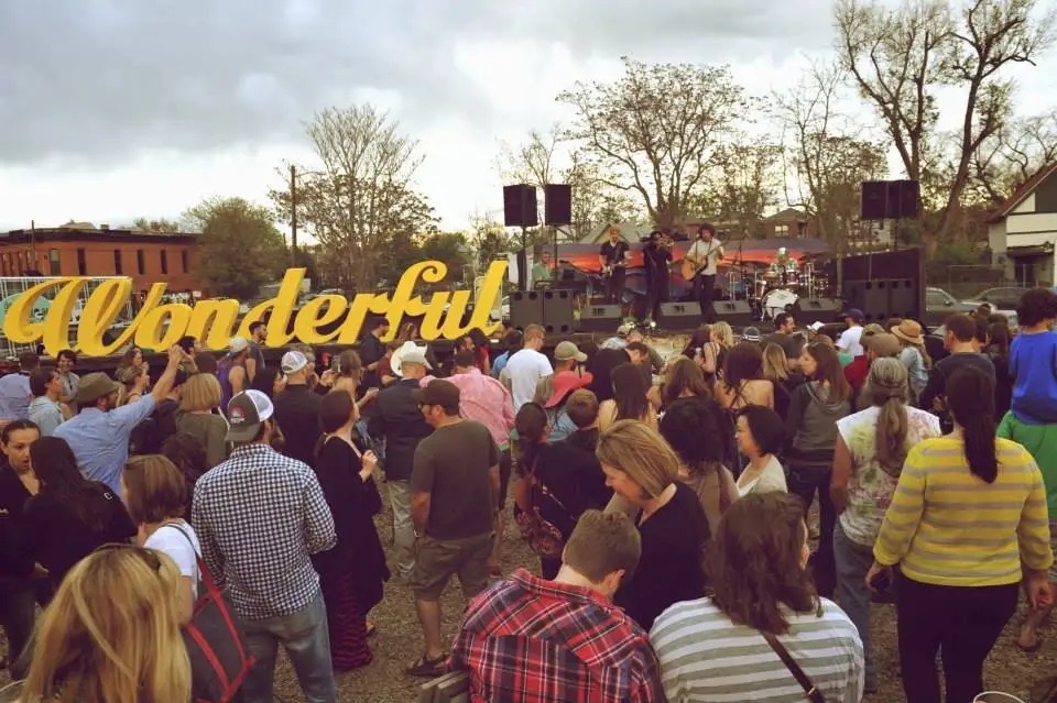 The crowd packed in front of the yellow Wonderful sign
