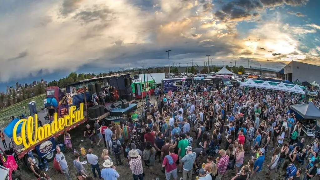 The crowd at dusk with the Wonderful sign lit behind them