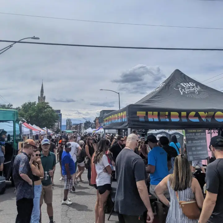 The anniversary crowd filling Larimer Street, downtown behind