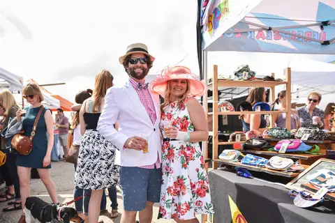 A couple in a floral hat and a pink shirt.