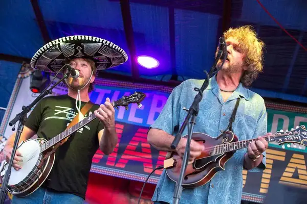 Drew Emmitt in a hat, mandolin up, mid-song