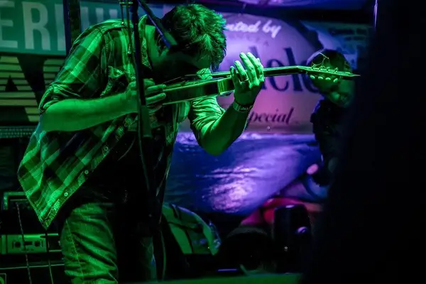 Jeff Austin on mandolin under blue stage light