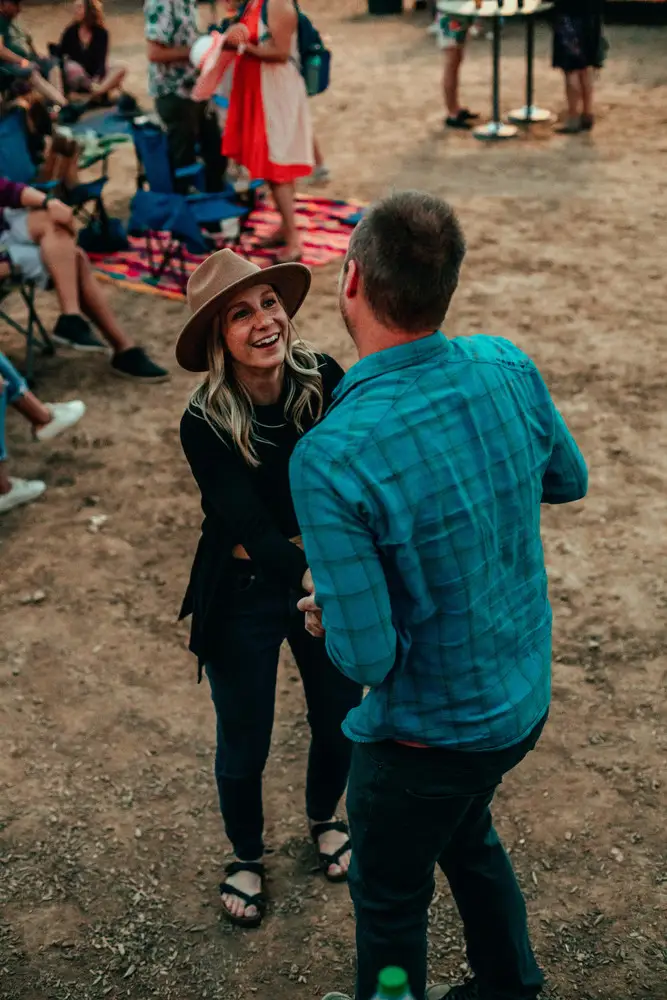 A couple dancing, him in a blue shirt.