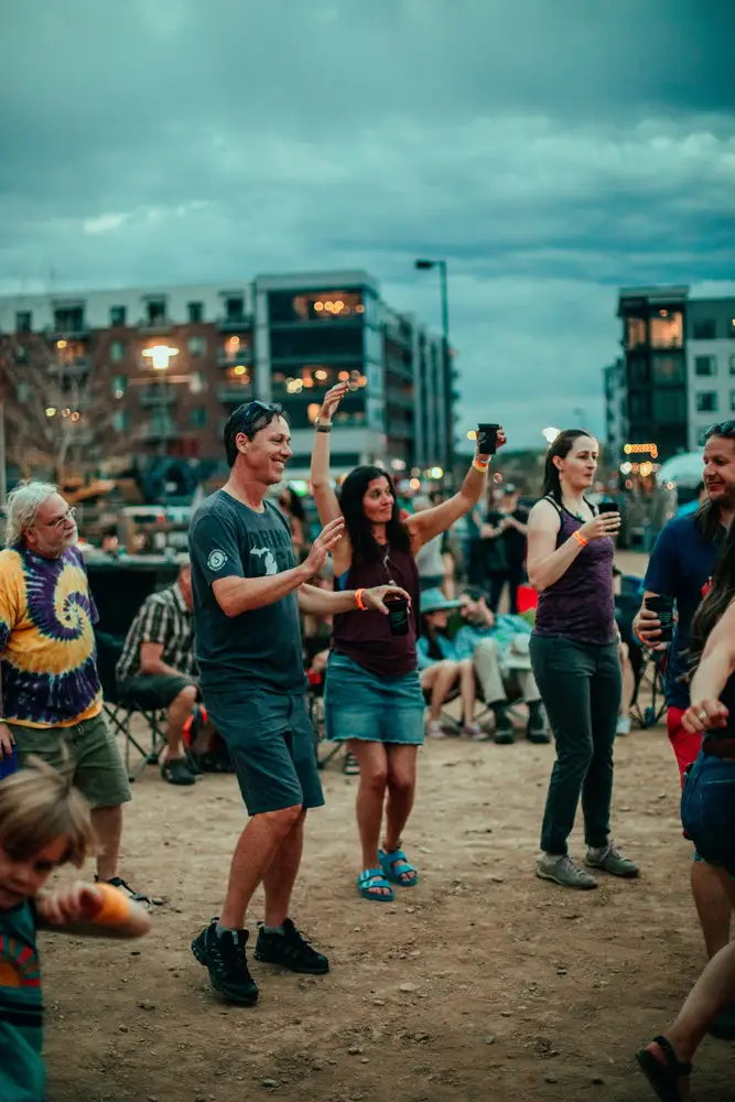 A crowd dancing with arms up.