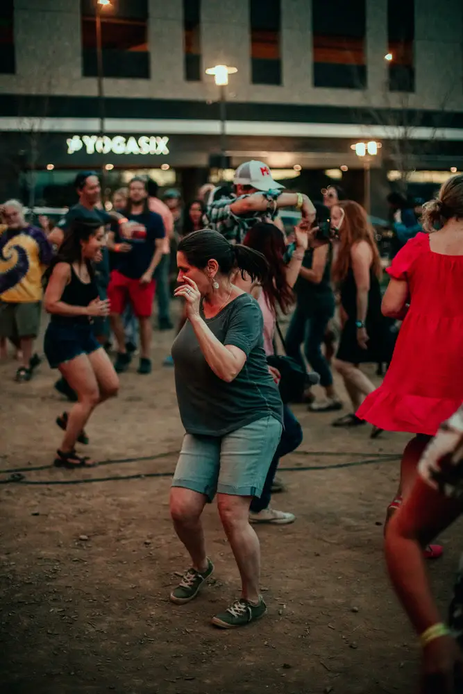 A couple dancing, him in a hat.